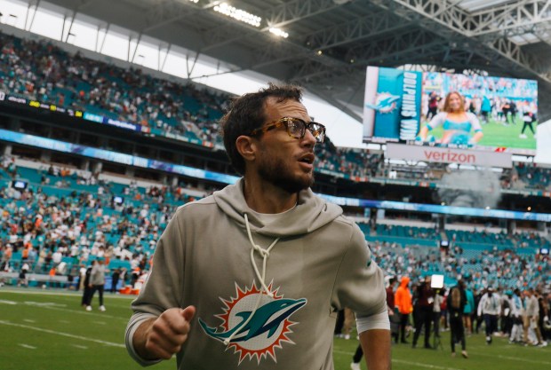 Miami Dolphins head coach Mike McDaniel runs off the field...