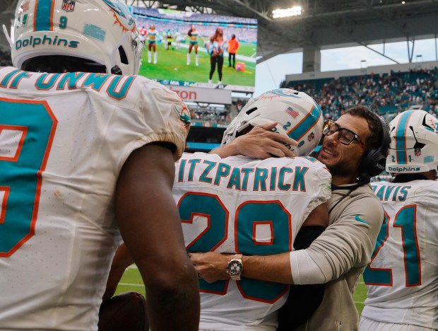 Miami Dolphins head coach Mike McDaniel congratulates Miami Dolphins safety...