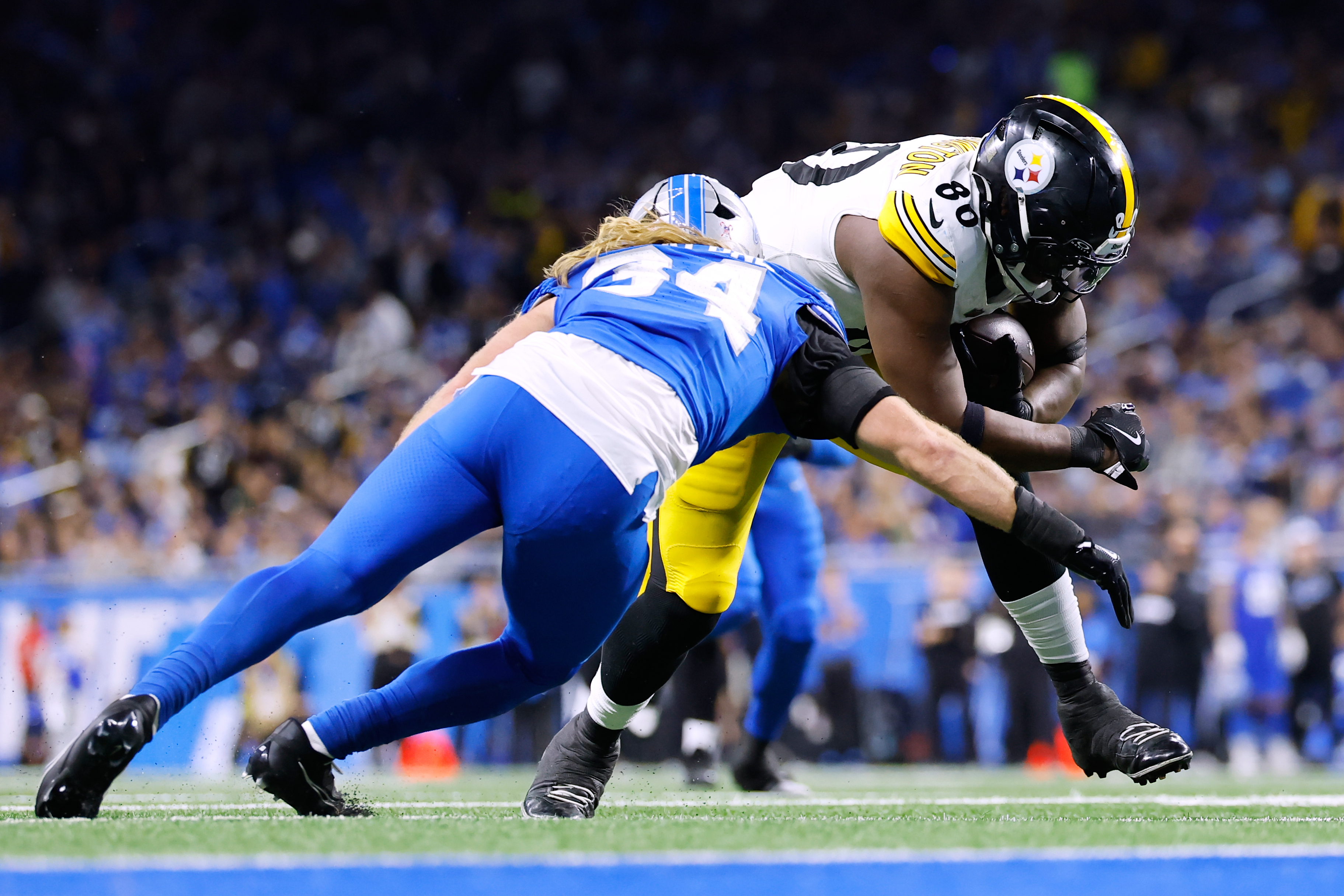 Pittsburgh Steelers’ Darnell Washington, right, is tackled by Detroit Lions’...