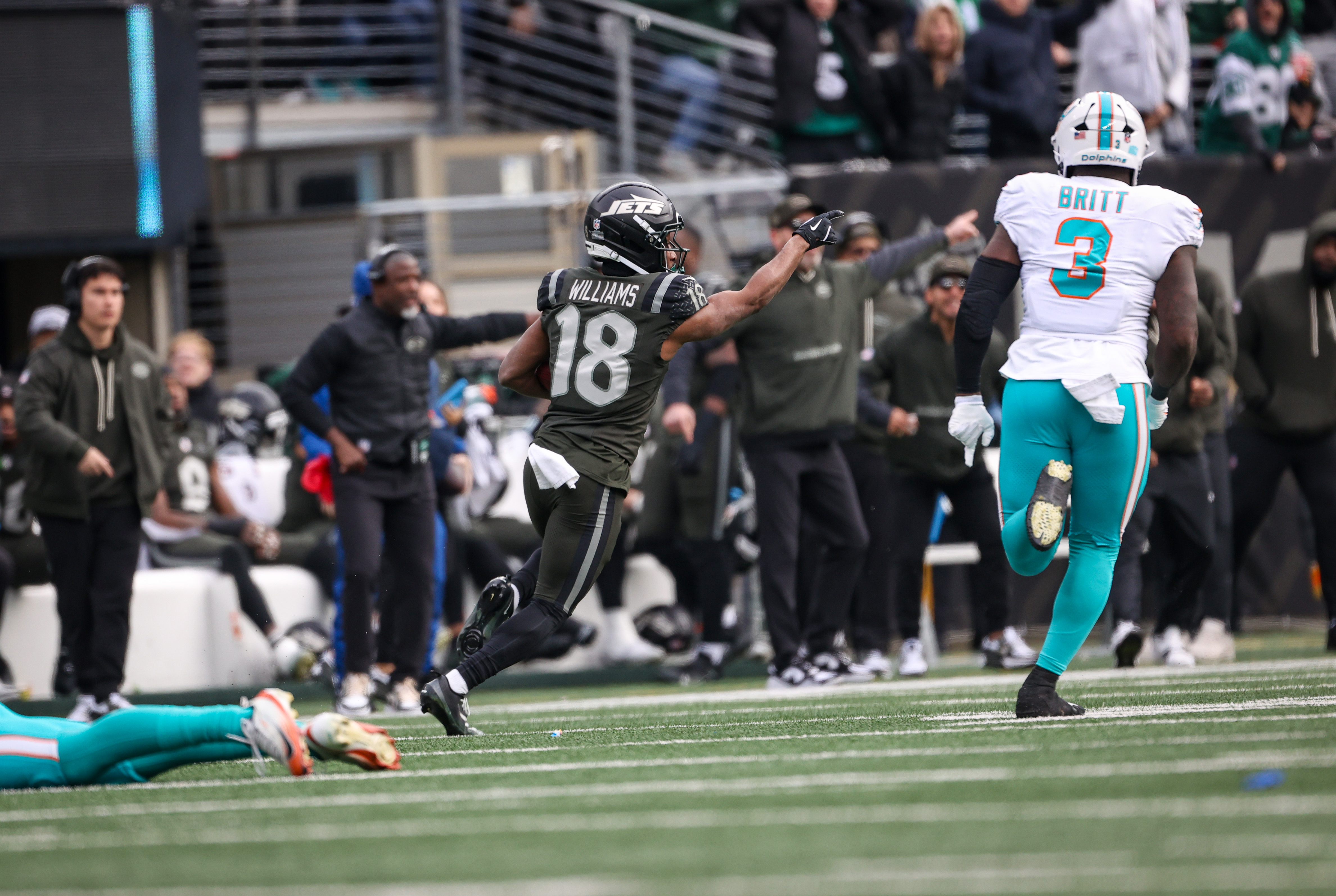 New York Jets return man Isaiah Williams (18) directs traffic as he takes a punt to the house for a first half touchdown against the Miami Dolphins, Sunday, Dec. 7, 2025 at MetLife Stadium in East Rutherford, N.J.