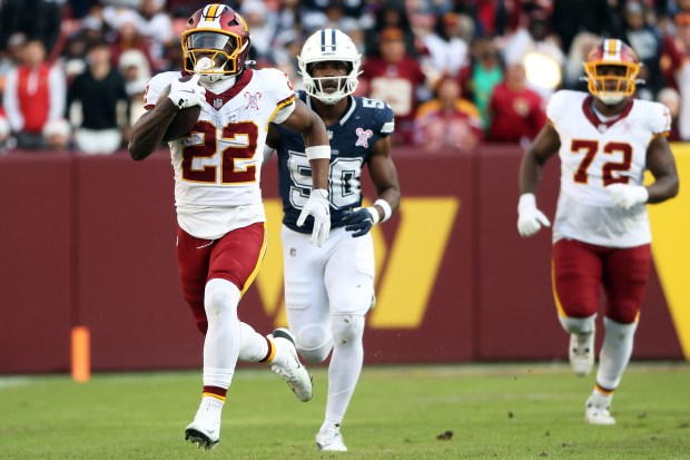 Washington Commanders running back Jacory Croskey-Merritt runs for a 72-yard touchdown against Dallas in the third quarter Thursday. He finished with 105 rushing yards and two touchdowns. (Daniel Kucin Jr./AP)