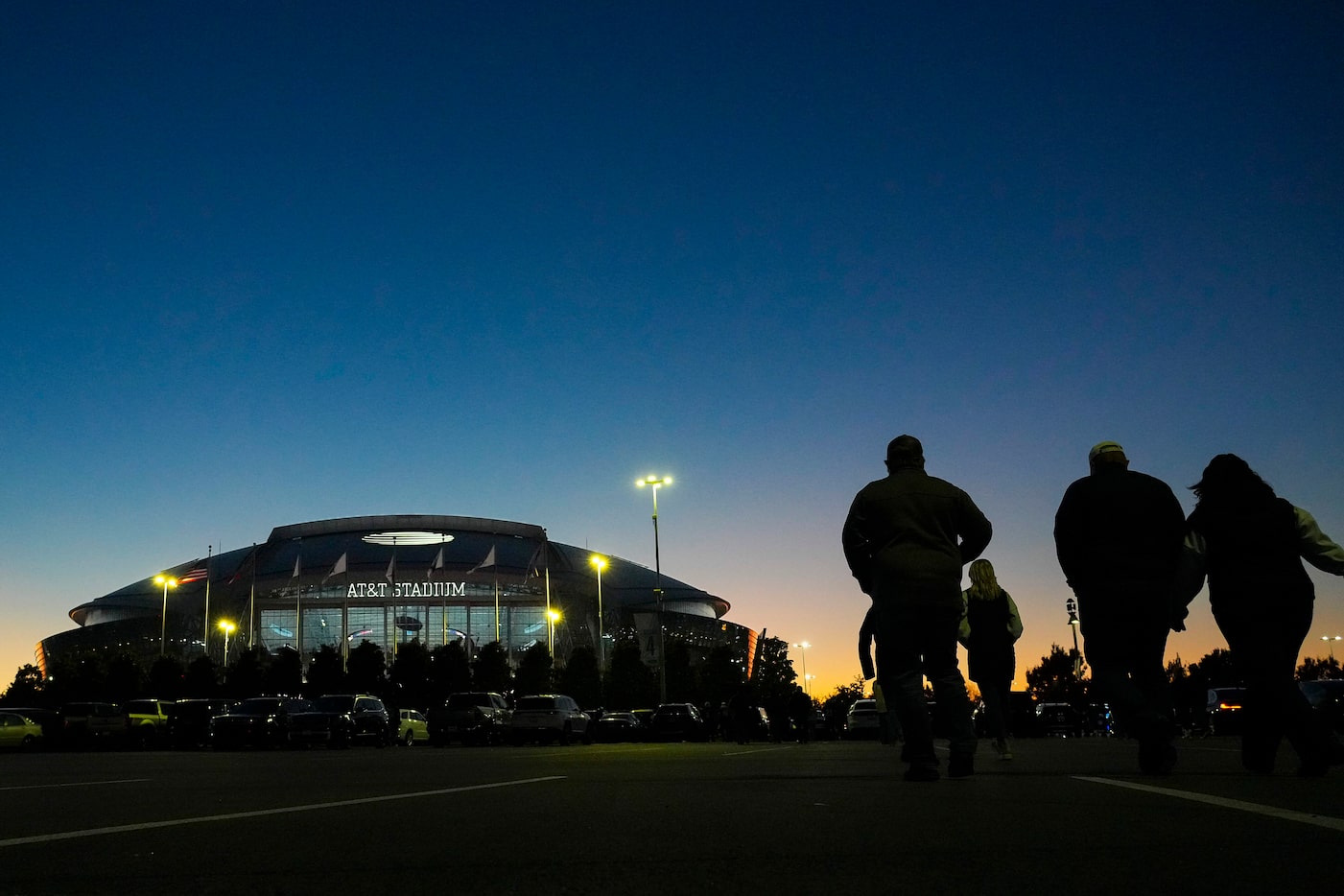 Fans head to the stadium before an NFL football game between the Dallas Cowboys and the...
