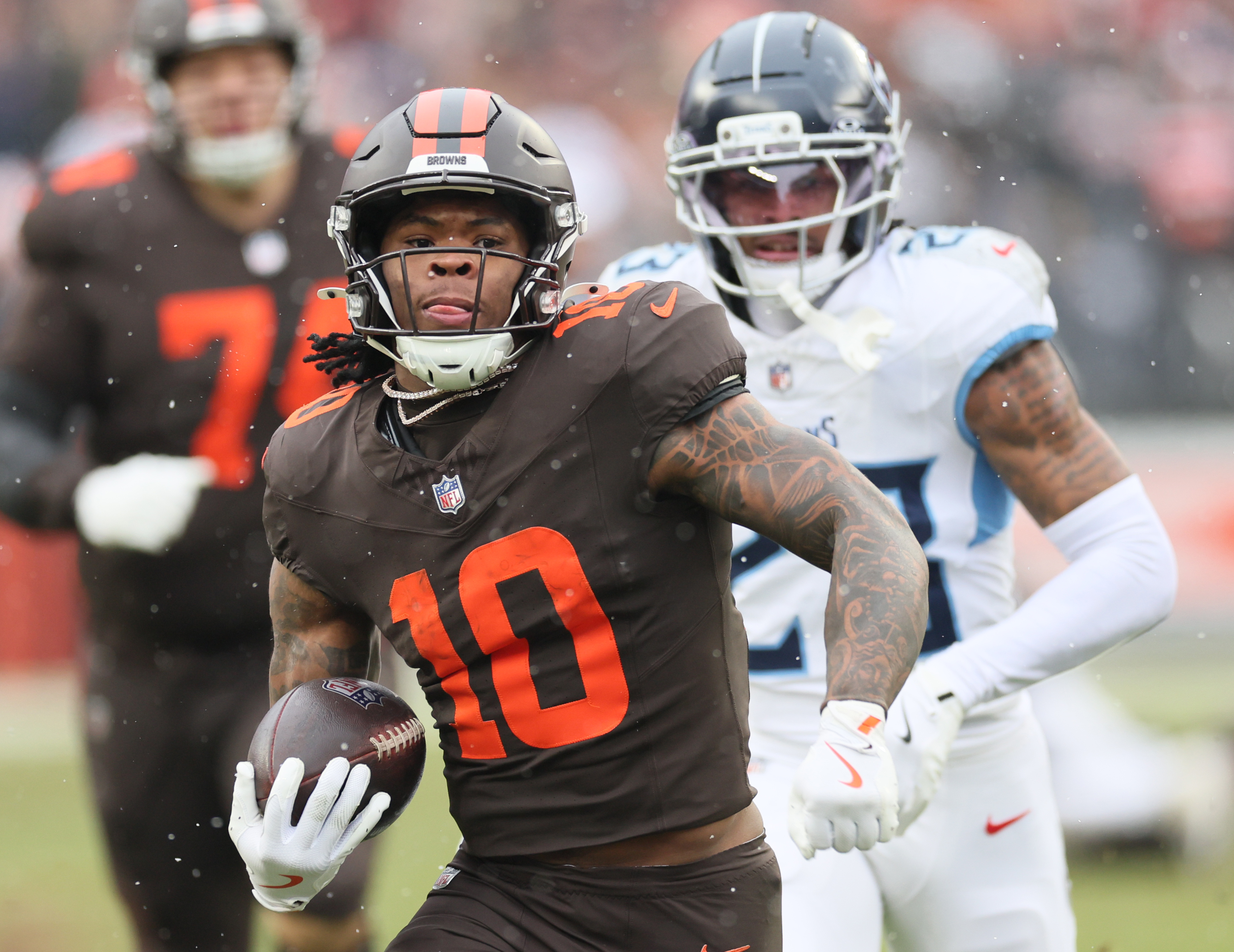 Cleveland Browns running back Quinshon Judkins finds running room on a long rush in the first half chased by Tennessee Titans safety Kevin Winston Jr. at Huntington Bank Field.