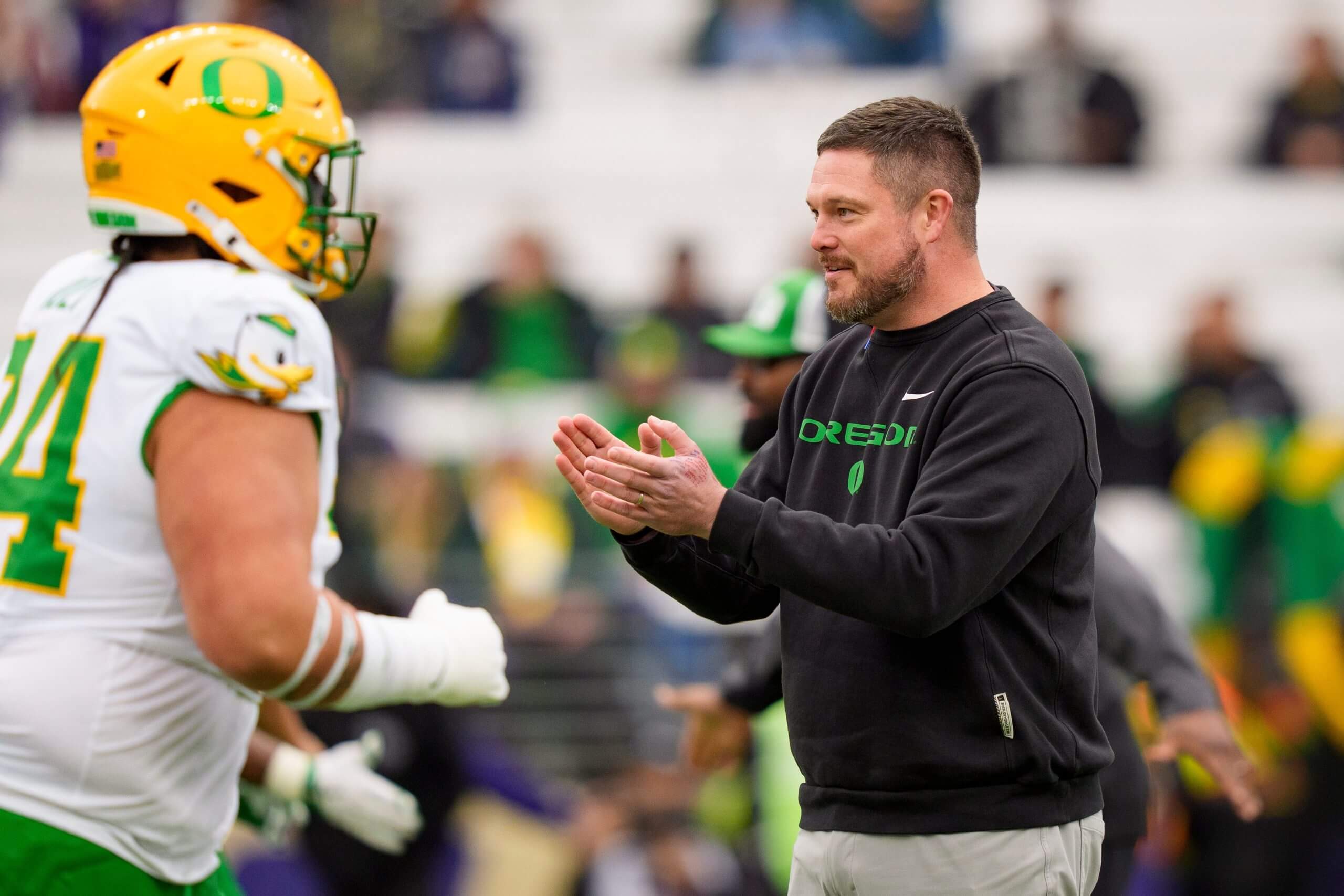 Dan Lanning claps his hands. 