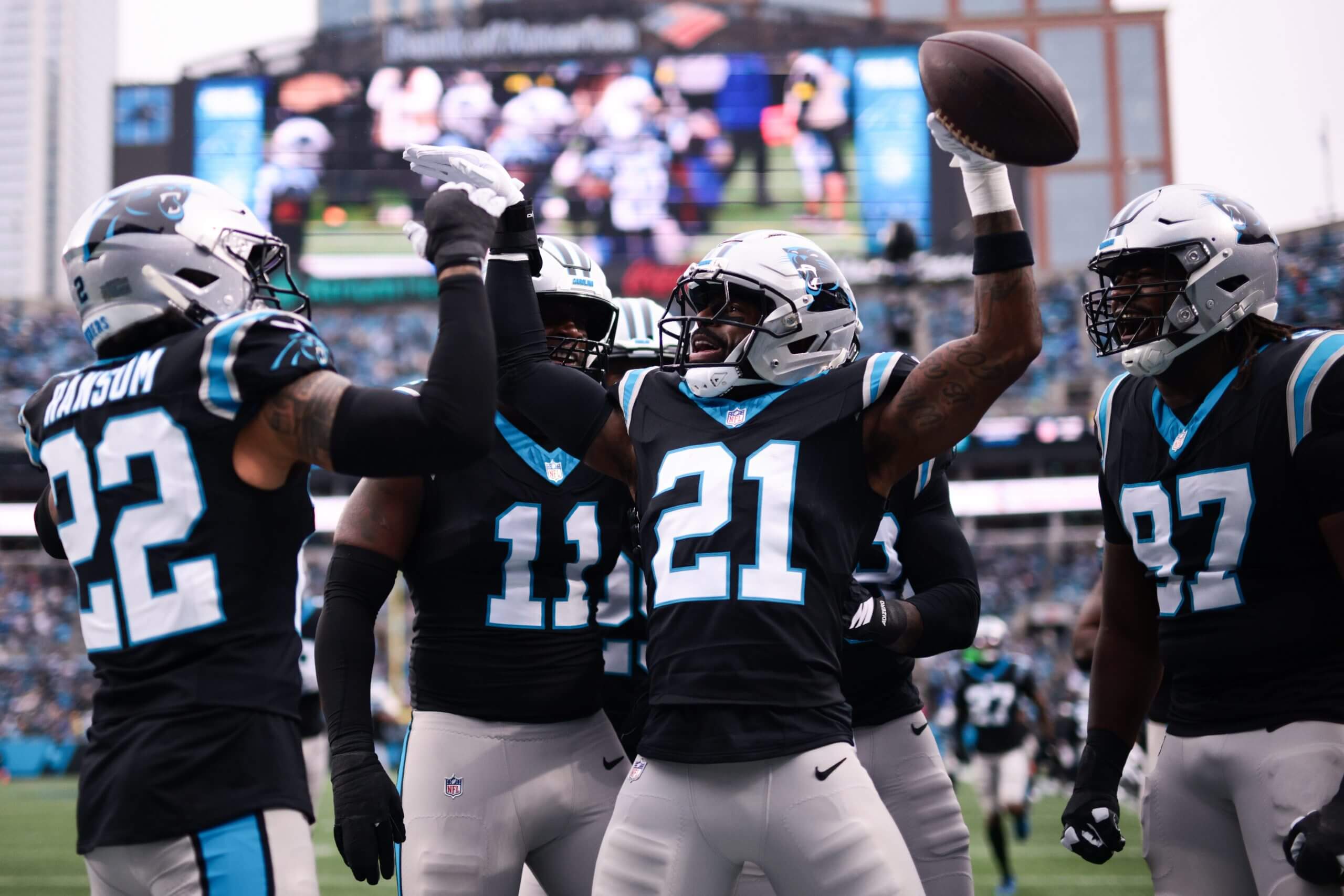 Carolina Panthers safety Nick Scott celebrates his first-quarter interception with teammates after the Panthers kept the Rams out of the end zone.