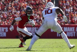 Nov 30, 2025; Tampa, Florida, USA; Tampa Bay Buccaneers wide receiver Emeka Egbuka (2) runs against Arizona Cardinals linebacker Josh Sweat (10) during the first half at Raymond James Stadium. Mandatory Credit: Nathan Ray Seebeck-Imagn Images