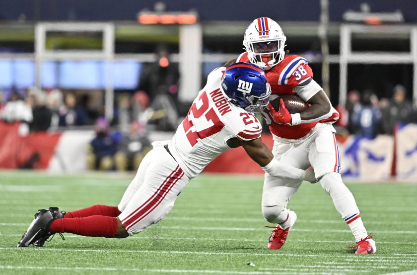 Dec 1, 2025; Foxborough, Massachusetts, USA; New England Patriots running back Rhamondre Stevenson (38) runs the ball against New York Giants safety Tyler Nubin (27) during the fourth quarter at Gillette Stadium.