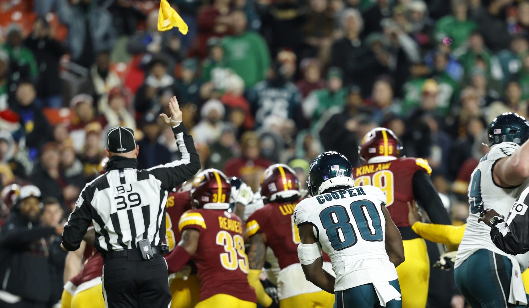 Dec 20, 2025; Landover, Maryland, USA; Back judge Rich Martinez (39) throws a flag into the air during a fight between Philadelphia Eagles and Washington Commanders players in the fourth quarter at Northwest Stadium.