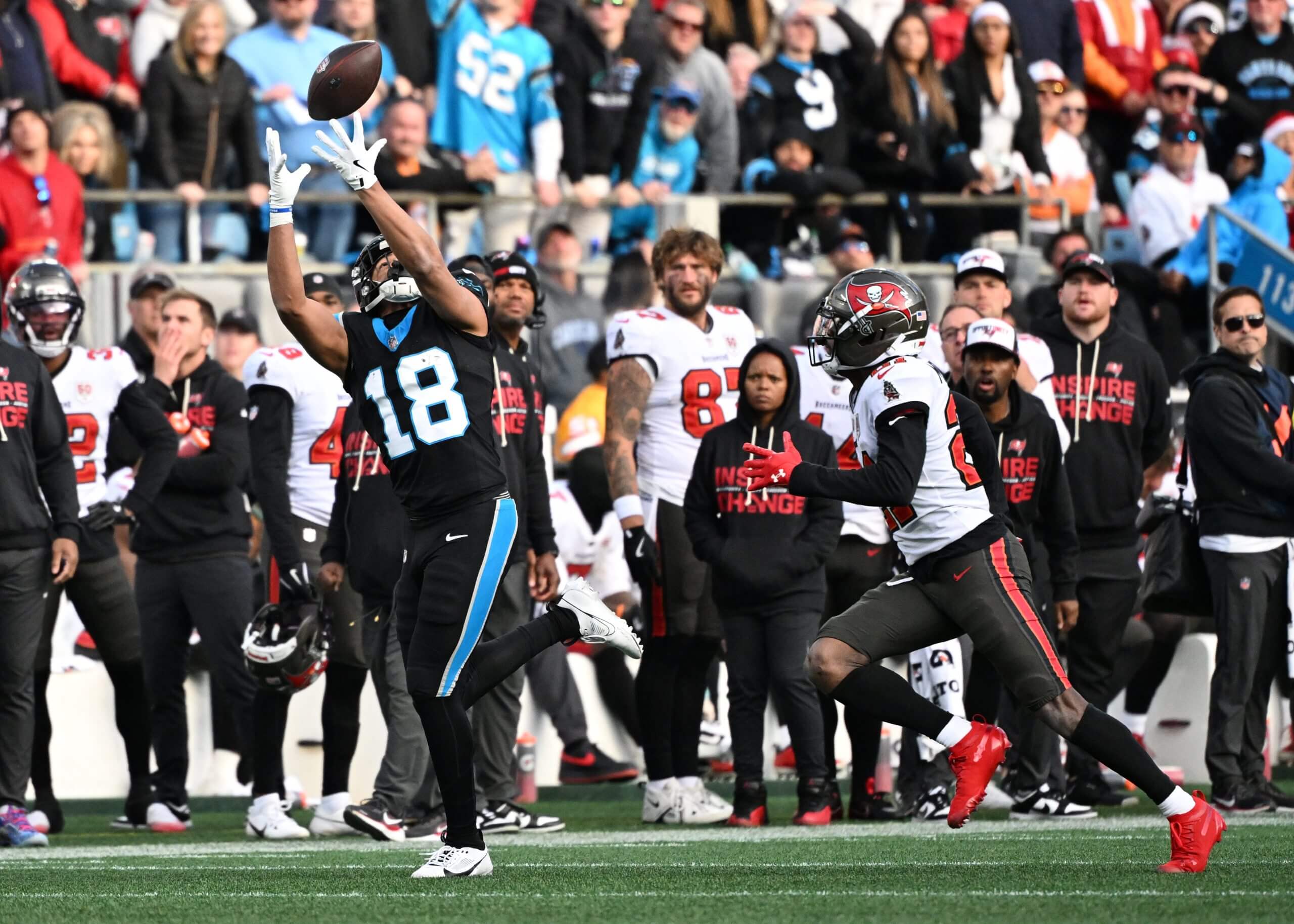 Carolina Panthers receiver Jalen Coker reaches out to catch a 34-yard pass from quarterback Bryce Young as a Tampa Bay defender pursues him in the fourth quarter.