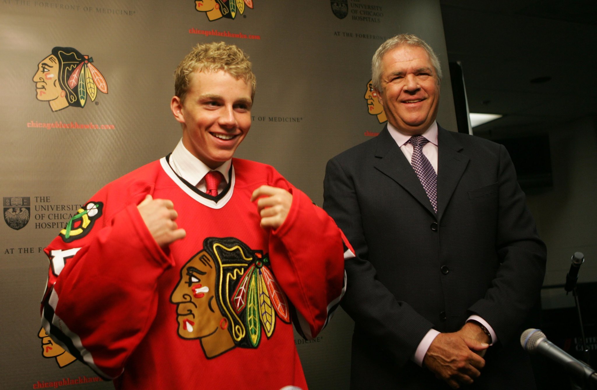 Patrick Kane, the No. 1 pick in the 2007 NHL draft, tries on his Blackhawks sweater alongside general manager Dale Tallon.