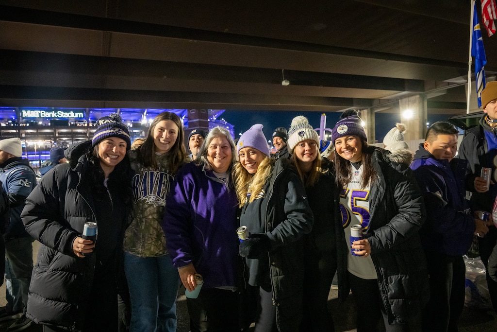Jill Cerroll, from center left, and Grace Marecki tailgate with friends  before the Baltimore Ravens host the New England Patriots at M&T Bank Stadium.