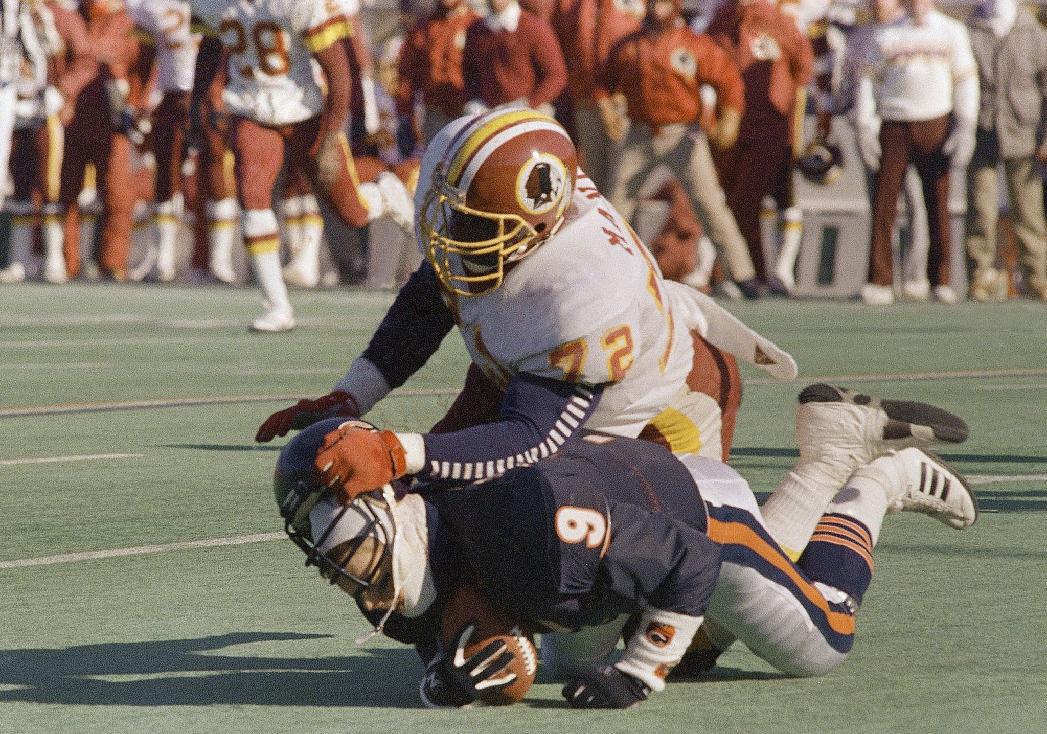 Bears quarterback Jim McMahon is sacked by Redskins' Dexter Manley during first quarter action in Chicago on Jan. 10, 1988.