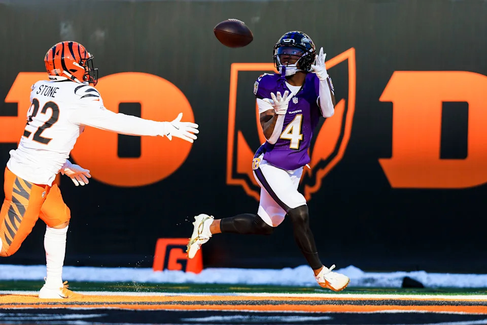 Dec 14, 2025; Cincinnati, Ohio, USA; Baltimore Ravens wide receiver Zay Flowers (4) catches a pass for a touchdown in the first half against Cincinnati Bengals safety Geno Stone (22) at Paycor Stadium. Mandatory Credit: Katie Stratman-Imagn Images