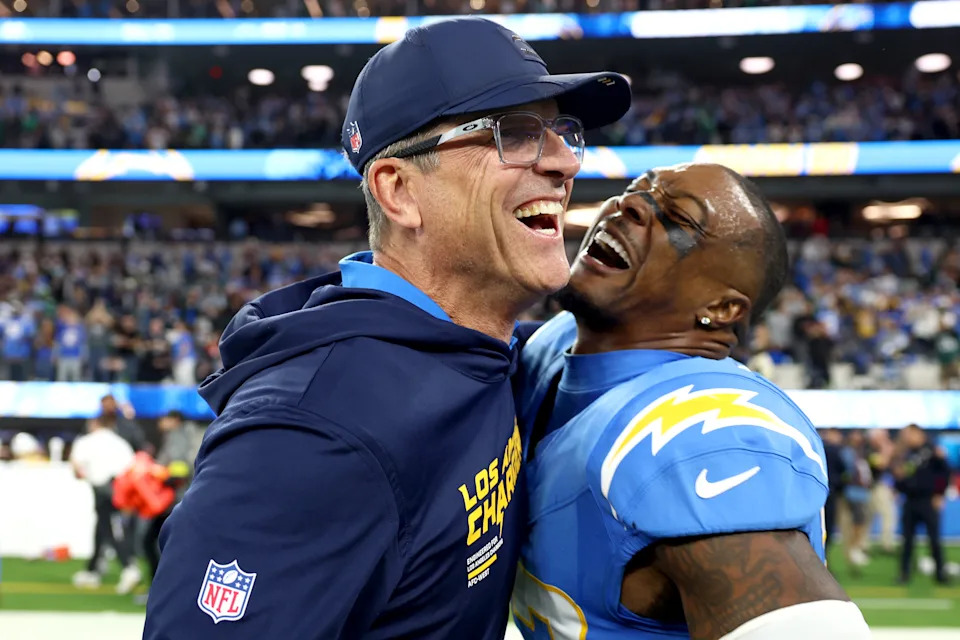 INGLEWOOD, CALIFORNIA - DECEMBER 08: Head coach Jim Harbaugh celebrates with Tony Jefferson #23 of the Los Angeles Chargers after Jefferson intercepted a pass during overtime to beat the Philadelphia Eagles 22-19 at SoFi Stadium on December 08, 2025 in Inglewood, California. (Photo by Katelyn Mulcahy/Getty Images)