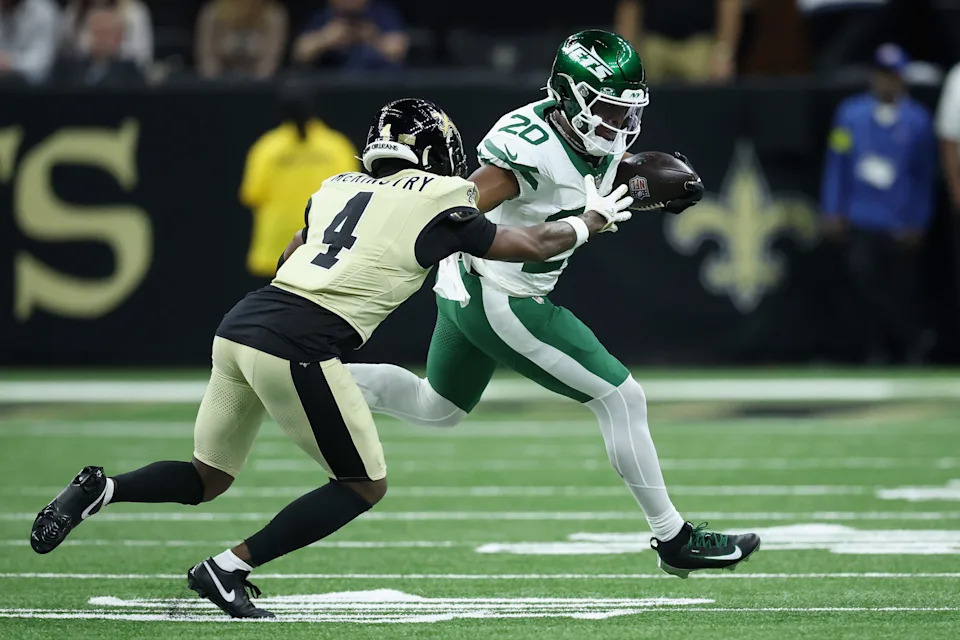 NEW ORLEANS, LOUISIANA - DECEMBER 21: Kool-Aid McKinstry #4 of the New Orleans Saints attempts to tackle Breece Hall #20 of the New York Jets during the second quarter at Caesars Superdome on December 21, 2025 in New Orleans, Louisiana. (Photo by Chris Graythen/Getty Images)