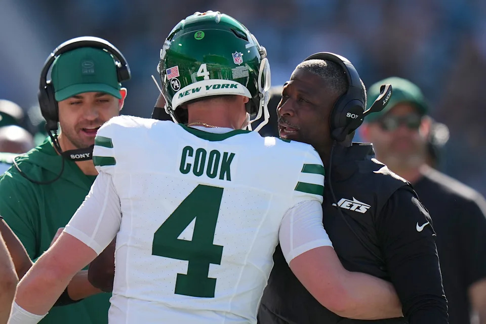 JACKSONVILLE, FLORIDA - DECEMBER 14: Head coach Aaron Glenn of the New York Jets celebrates with Brady Cook #4 during the first quarter against the Jacksonville Jaguars at EverBank Stadium on December 14, 2025 in Jacksonville, Florida. (Photo by Rich Storry/Getty Images)