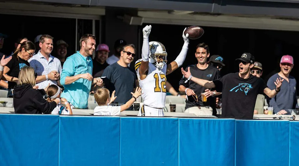 New Orleans Saints wide receiver Chris Olave celebrates a touchdown against the Carolina Panthers at Bank of America Stadium in Charlotte on Nov. 9th after hopping into the end zone seats of some Panthers fans. The Saints won, 17-7, and outgained Carolina, 388-175.