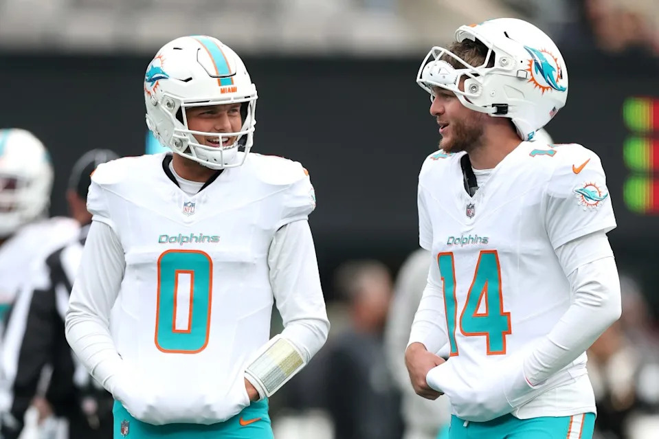 Zach Wilson (left) and Quinn Ewers speak during warmups before the Dolphins’ road win over the Jets on Dec. 7. Getty Images