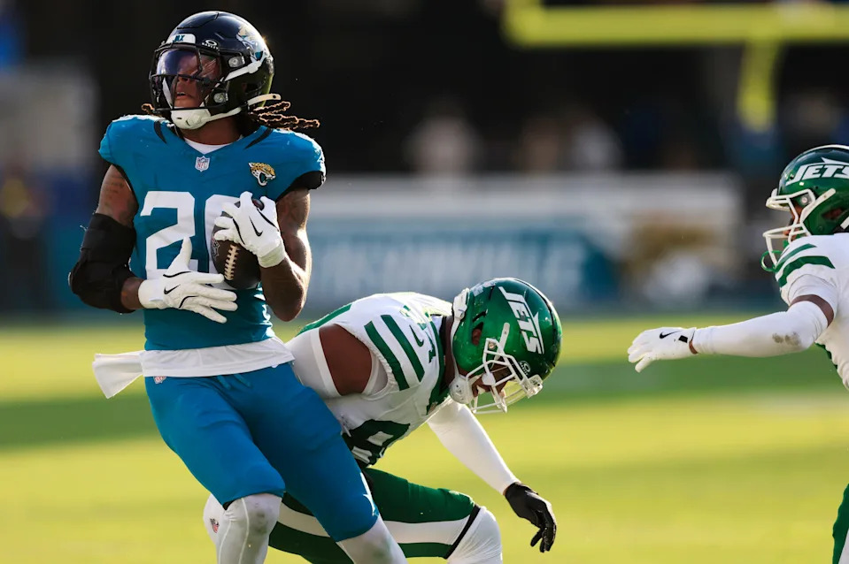 Jacksonville Jaguars safety Antonio Johnson (26) spins from New York Jets tight end Stone Smartt (84) on an interception during the fourth quarter of an NFL football matchup at EverBank Stadium, Sunday, Dec. 14, 2025, in Jacksonville, Fla. The Jaguars defeated the Jets 48-20. [Corey Perrine/Florida Times-Union]