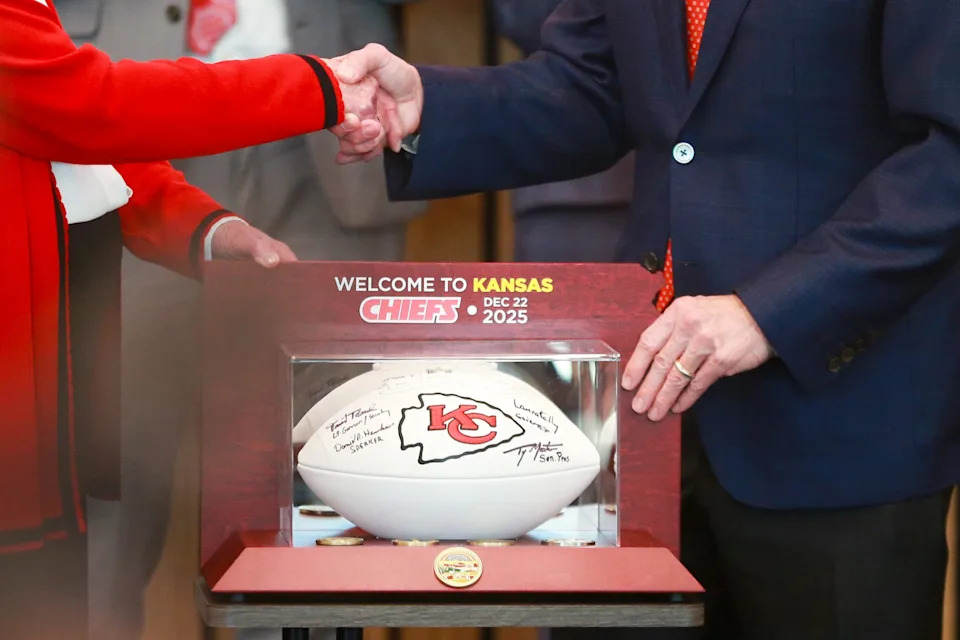 Kansas Gov. Laura Kelly and Kansas City Chiefs CEO Clark Hunt shake hands inside the Robert B. Docking State Office Building on Monday, Dec. 22.