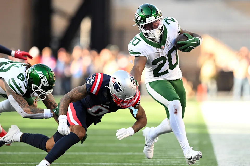 Oct 27, 2024; Foxborough, Massachusetts, USA; New York Jets running back Breece Hall (20) runs against New England Patriots cornerback Christian Gonzalez (0) during the second half at Gillette Stadium. Mandatory Credit: Brian Fluharty-Imagn Images