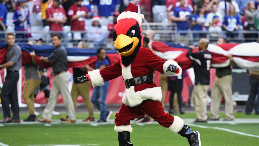The Arizona Cardinals mascot, Big Red, runs on the field in a Santa Claus costume for the NFL game ...