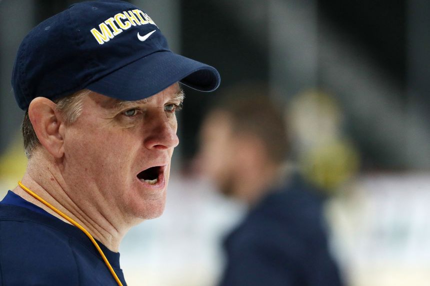 Michigan head coach Mel Pearson directs his players during NCAA college hockey practice, Wednesday, April 4, 2018, in St. Paul. Minn.