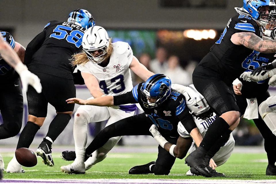 Jared Goff of the Detroit Lions fumbles the ball against Dallas Turner and Andrew van Ginkel of the Minnesota Vikings during the fourth quarter at U.S. Bank Stadium in Minneapolis on Thursday, Dec. 25, 2025.