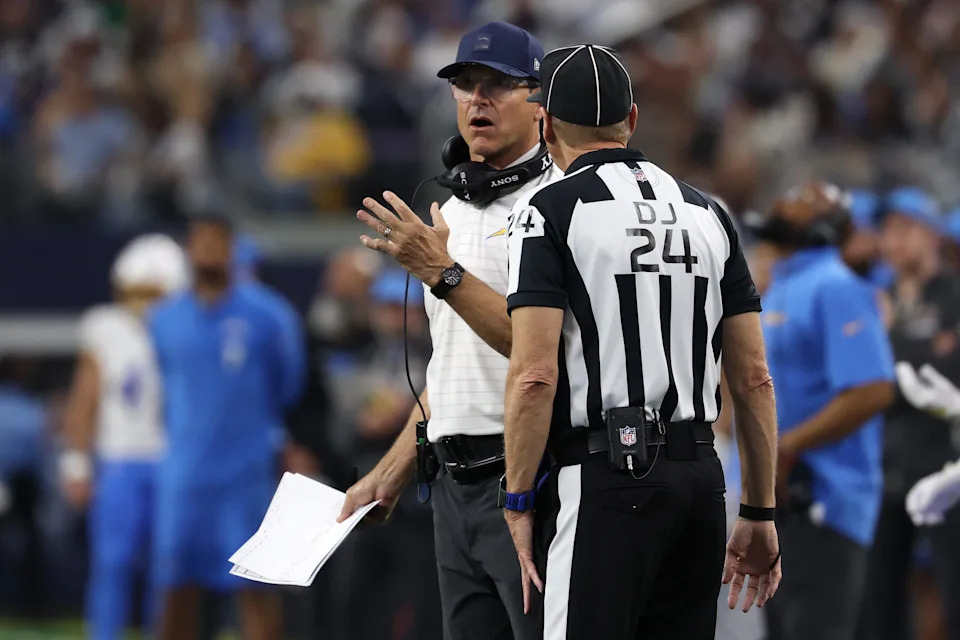 ARLINGTON, TEXAS - DECEMBER 21: Head coach Jim Harbaugh of the Los Angeles Chargers speaks to the referee in the second quarter of the game against the Dallas Cowboys at AT&T Stadium on December 21, 2025 in Arlington, Texas. (Photo by Stacy Revere/Getty Images)