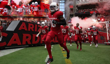 Cardinals Max Melton runs out of the tunnel...