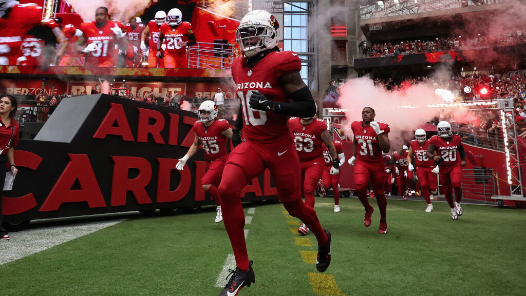 Cardinals Max Melton runs out of the tunnel...