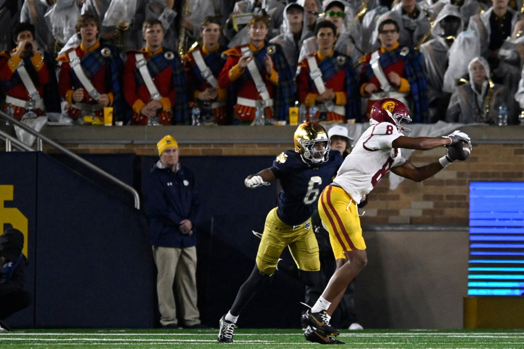 USC receiver Ja'Kobi Lane (8) catches a touchdown pass over Notre Dame's Christian Gray (6).
