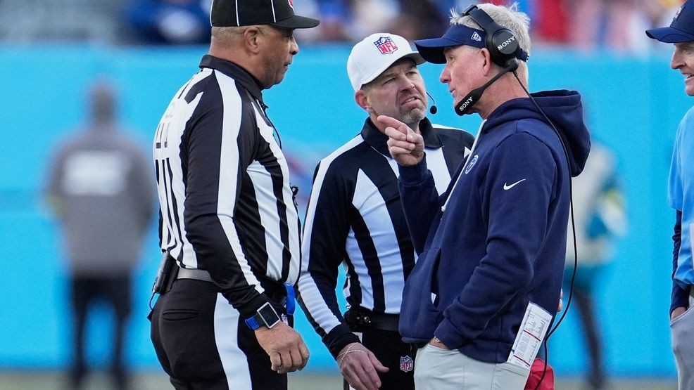 Tennessee Titans head coach Mike McCoy, right, has a discussion with officials during the second half of an NFL football game between the Tennessee Titans and the Jacksonville Jaguars Sunday, Nov. 30, 2025, in Nashville, Tenn. (AP Photo/George Walker IV)