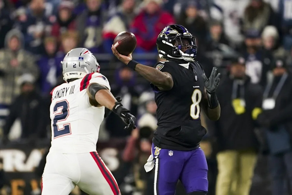 Dec 21, 2025; Baltimore, Maryland, USA; Baltimore Ravens quarterback Lamar Jackson (8) passes against New England Patriots linebacker Harold Landry III (2) during the first half of the game at M&T Bank Stadium. Mitch Stringer-Imagn Images