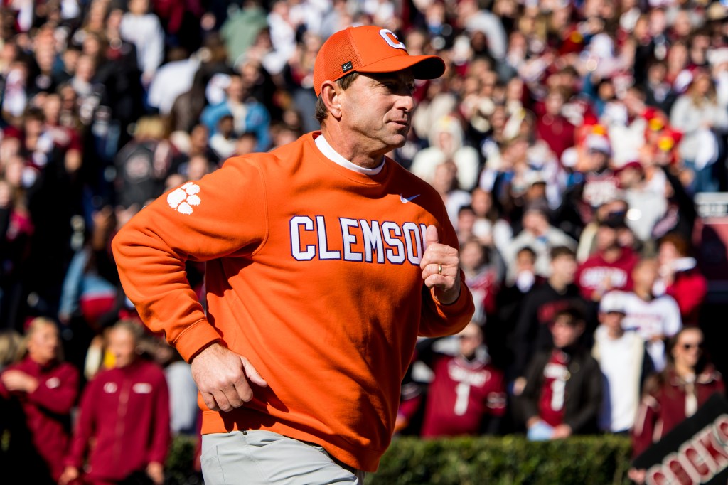 Clemson Tigers head coach Dabo Swinney leads his team onto the field.