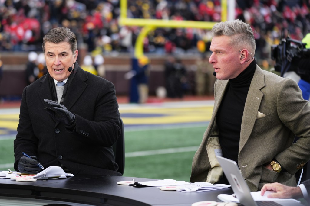 College Game Day hosts Rece Davis, left, and Pat McAfee speak on air before an NCAA college football game between Michigan and Ohio State.