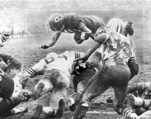Gale Sayers plunges over the line from yard out for the fifth of his six touchdowns for the Bears in Wrigley Field against the 49ers on Dec. 12, 1965. Editor's note: This historic print shows crop markings. (Chicago's American)