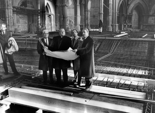 Thomas Henry, the general contractor, from left, Cardinal Cody, C.F. Murphy Jr., architect, and the Rev. Timothy J. Lyne, rector, view the blueprints for the $2 million dollar reconstruction project in Holy Name Cathedral on Nov. 26, 1968. The work was expected to be finished the following year. (William Yates/Chicago Tribune)