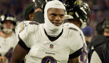Baltimore Ravens quarterback Lamar Jackson (8) passes as head coach John Harbaugh looks prior to the game against the Los Angeles Chargers in a AFC Wild Card playoff football game at M&T Bank Stadium.