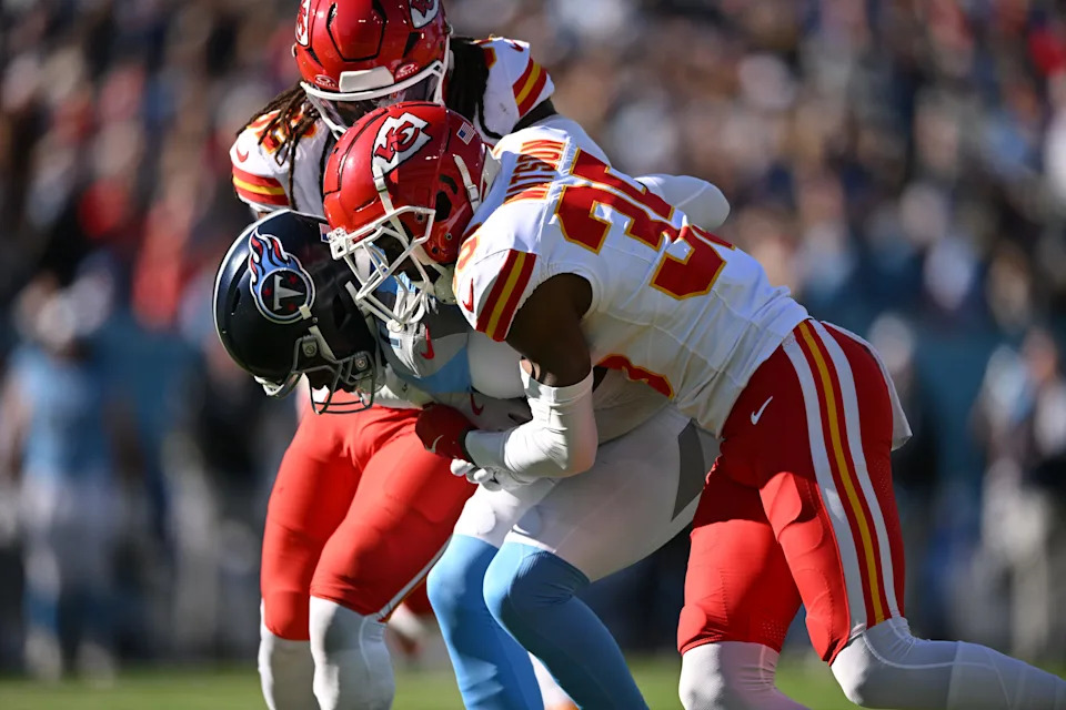Dec 21, 2025; Nashville, Tennessee, USA; Kansas City Chiefs linebacker Nick Bolton (32) and cornerback Jaylen Watson (35) tackle Tennessee Titans wide receiver Van Jefferson (11) during the first half at Nissan Stadium. Mandatory Credit: Steve Roberts-Imagn Images