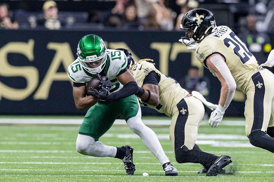 Dec 21, 2025; New Orleans, Louisiana, USA; New Orleans Saints safety Justin Reid (21) tackles New York Jets wide receiver Adonai Mitchell (15) during the second half at Caesars Superdome. Mandatory Credit: Stephen Lew-Imagn Images