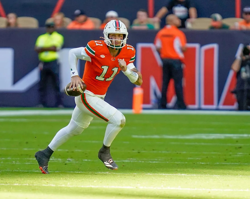 Nov 8, 2025; Miami Gardens, Florida, USA; Miami Hurricanes quarterback Carson Beck (11) rushes the ball against the Syracuse Orange during the first quarter at Hard Rock Stadium. Mandatory Credit: Jeff Romance-Imagn Images