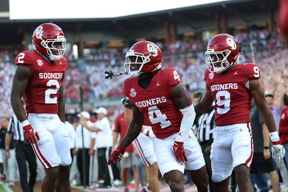 Sep 6, 2025; Norman, Oklahoma, USA; Oklahoma Sooners wide receiver Deion Burks (4) celebtrates with wide receiver Keontez Lewis (9) and running back Jovantae Barnes (2) after scoring a touchdown against the Michigan Wolverines during the first half at Gaylord Family-Oklahoma Memorial Stadium. Mandatory Credit: Kevin Jairaj-Imagn ImagesKevin Jairaj-Imagn Images
