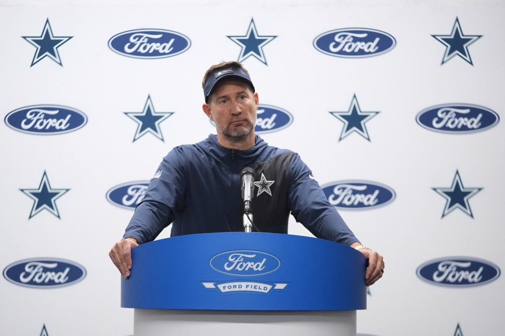 Dallas Cowboys coach Brian Schottenheimer speaking at a press conference.