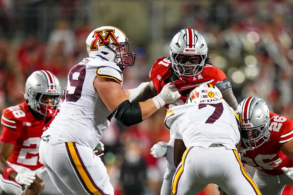 Ohio State Buckeyes safety Leroy Roker (28), defensive lineman Jarquez Carter (91) and linebacker Payton Pierce (26) attempt to tackle Minnesota Golden Gophers running back Fame Ijeboi (7) in the second half of the NCAA football game at Ohio Stadium on Saturday, Oct. 4, 2025 in Columbus, Ohio.