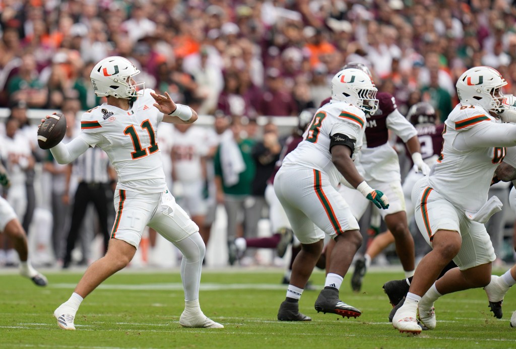 Miami QB Carson Beck (11) looks to pass against the Aggies on Dec. 20, 2025.