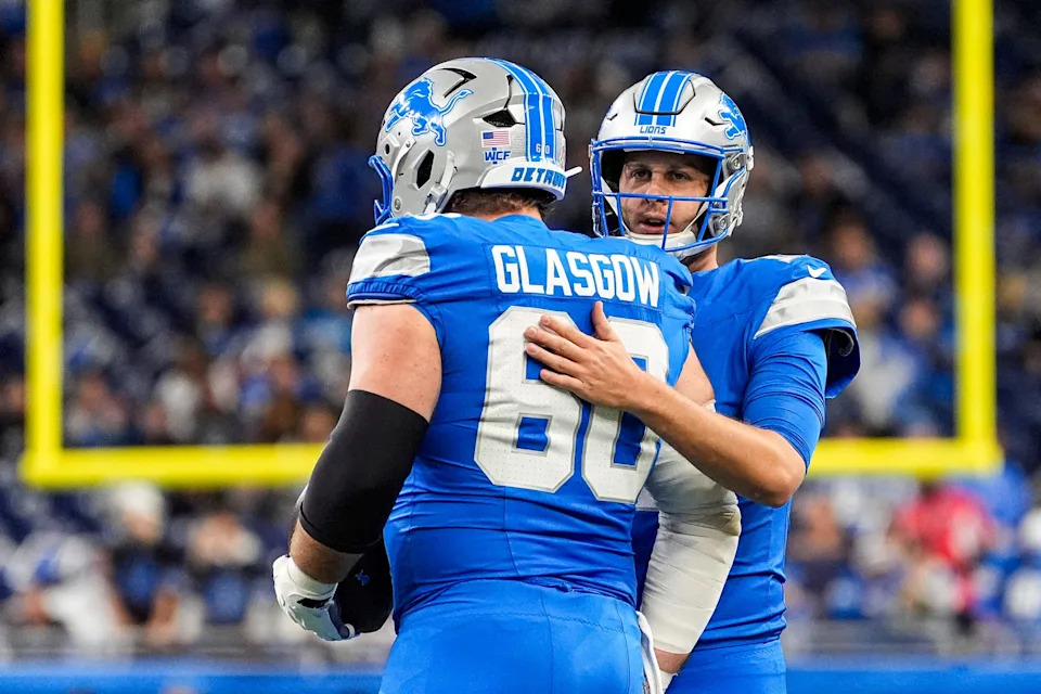 Detroit Lions guard Graham Glasgow (60) talks to quarterback Jared Goff (16) at warmup ahead of the Minnesota Vikings game at Ford Field in Detroit on Sunday, November 2, 2025.