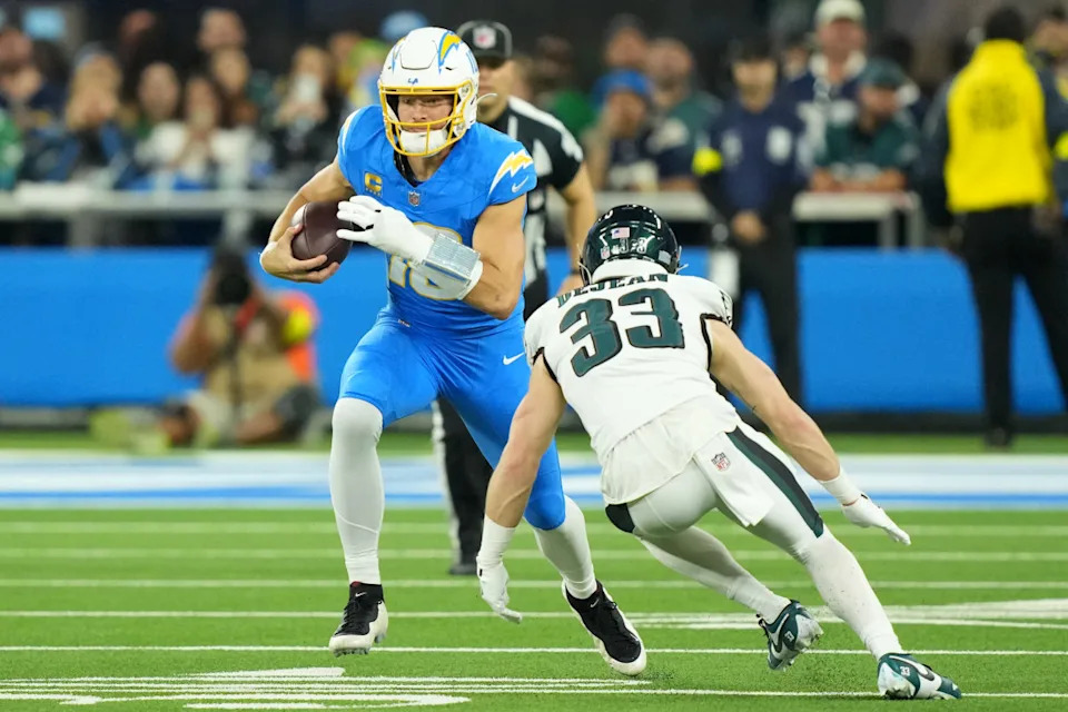 Dec 8, 2025; Inglewood, California, USA; Los Angeles Chargers quarterback Justin Herbert (10) runs against Philadelphia Eagles cornerback Cooper Dejean (33) at SoFi Stadium. Credit: Kirby Lee-Imagn Images