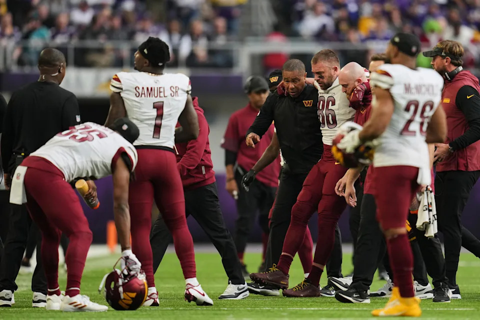 Washington Commanders tight end Zach Ertz (86) is helped to walk off the field after an injury during the second half of an NFL football game against the Minnesota Vikings, Sunday, Dec. 7, 2025, in Minneapolis. (AP Photo/Abbie Parr)