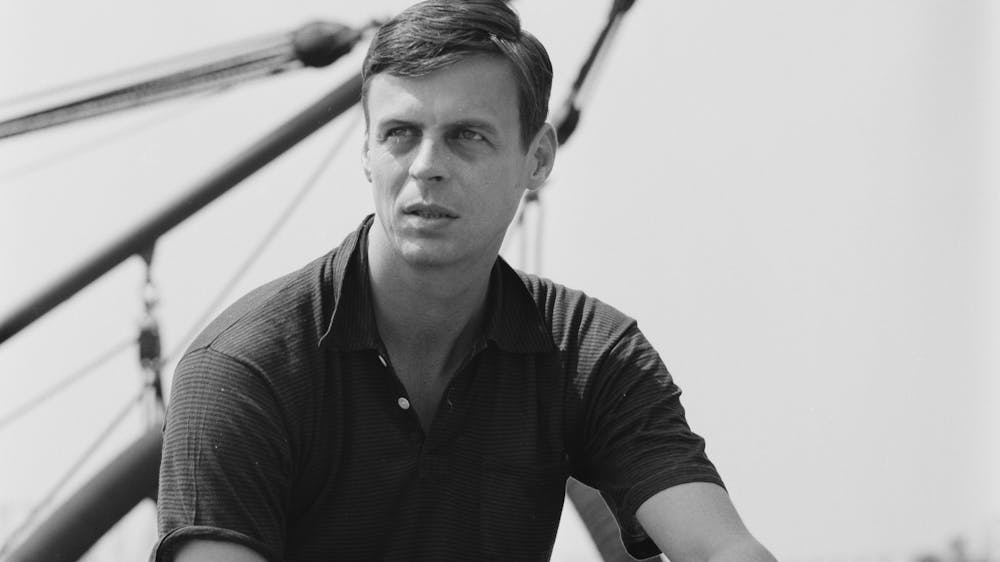 American writer George Plimpton sits and poses for a portrait photo